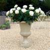 White roses in garden urn